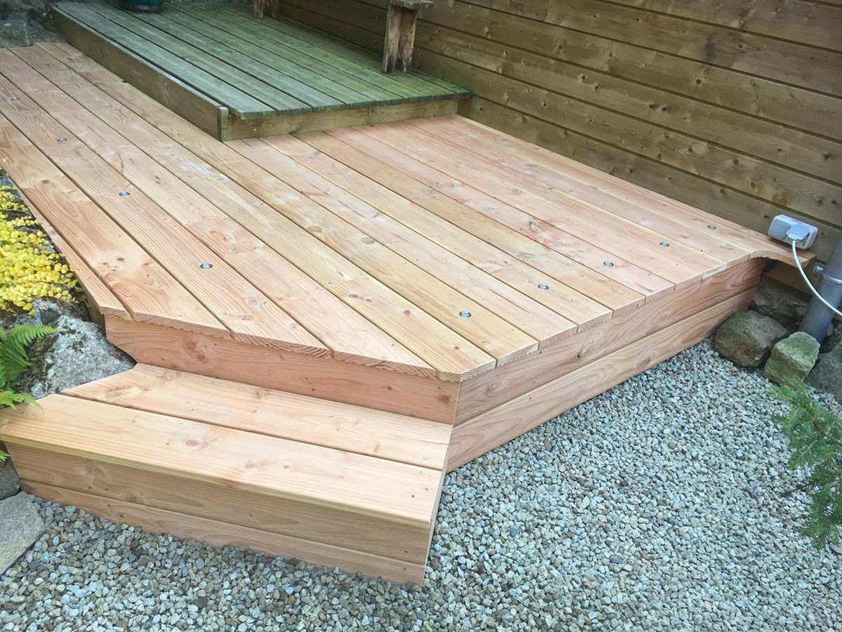 Petite extension de terrasse dans un jardin paysager