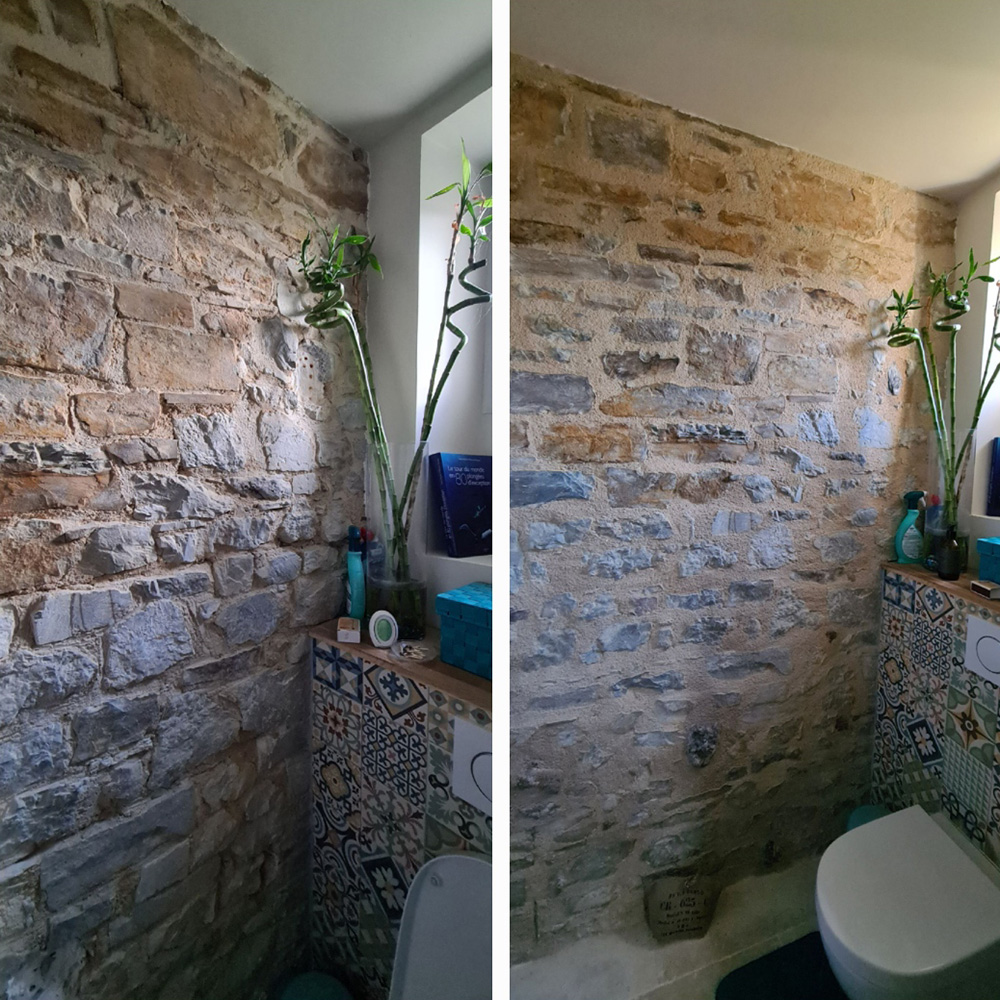 Réalisation des joints à la chaux sur un mur en pierres dans une salle de bain